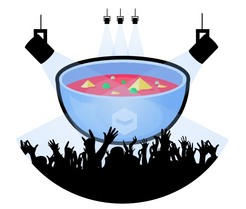 A giant bowl of soup on a well lit stage with the salutes of a crowd in front.